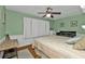 Bedroom with king-size bed, ceiling fan, and wood flooring at 162 Croop Se Ln, Port Charlotte, FL 33952