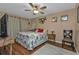 Bedroom with king-size bed, ceiling fan, and wood flooring at 162 Croop Se Ln, Port Charlotte, FL 33952
