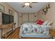 Bedroom with king-size bed, ceiling fan, and wood flooring at 162 Croop Se Ln, Port Charlotte, FL 33952