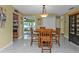 Bright dining room with wood table and chairs, adjacent to kitchen at 162 Croop Se Ln, Port Charlotte, FL 33952