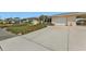 Front view of a single-story house with a large driveway at 162 Croop Se Ln, Port Charlotte, FL 33952