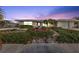 House exterior at dusk, featuring landscaping and a teal door at 162 Croop Se Ln, Port Charlotte, FL 33952