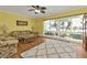 Living room with hardwood floors, large windows, and comfy seating at 162 Croop Se Ln, Port Charlotte, FL 33952