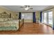 Large main bedroom with wood flooring and access to the pool at 162 Croop Se Ln, Port Charlotte, FL 33952
