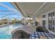 Spacious patio with pool view, table and chairs, and a grill at 162 Croop Se Ln, Port Charlotte, FL 33952