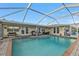 Stunning pool and patio area with covered lanai and lush landscaping at 162 Croop Se Ln, Port Charlotte, FL 33952