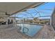 Inviting pool area with covered patio, brick pavers, and ample seating at 162 Croop Se Ln, Port Charlotte, FL 33952