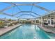Large, refreshing pool with covered patio and lush landscaping at 162 Croop Se Ln, Port Charlotte, FL 33952