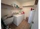 Bright laundry room with washer, dryer, and utility sink at 164 Chelsea Nw Ct, Port Charlotte, FL 33952