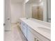 Double vanity bathroom with a large mirror at 17565 Opal Sand Dr # 201, Venice, FL 34293