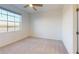 Well-lit bedroom with window, ceiling fan and carpet at 17565 Opal Sand Dr # 201, Venice, FL 34293