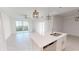 Modern kitchen with white cabinets, island, and stainless steel appliances at 17565 Opal Sand Dr # 201, Venice, FL 34293