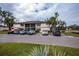 Condo parking lot with several cars parked and landscaping at 19505 Quesada Ave # U201, Port Charlotte, FL 33948