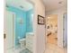 Light blue bathroom with white vanity, toilet, and view into bedroom at 20352 Andover Ave, Port Charlotte, FL 33954