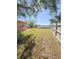 Large backyard with grassy area and wooden fence at 21061 Midway Blvd, Port Charlotte, FL 33952