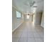 Spacious living room featuring tile floors and ceiling fan at 21061 Midway Blvd, Port Charlotte, FL 33952