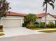 Tan, two-car garage villa with tile roof at 2522 Thyme Way, North Port, FL 34289