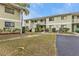 Exterior view of a light green building with parking at 25225 Rampart Blvd # 1606, Punta Gorda, FL 33983