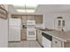 Kitchen with white appliances and light cabinets at 25225 Rampart Blvd # 1606, Punta Gorda, FL 33983