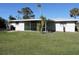 Exterior view of a single story home with a screened patio at 253 Holly Rd, Venice, FL 34293