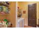 Laundry room with washer, dryer, and storage shelves at 25606 Aysen Dr, Punta Gorda, FL 33983