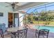 Screened patio with pool view and outdoor dining set at 25606 Aysen Dr, Punta Gorda, FL 33983