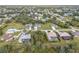 Aerial view showing the home's location in a residential neighborhood with mature landscaping at 27252 & 27260 Porto Nacional Dr, Punta Gorda, FL 33983