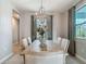 Bright dining room with wood table and modern chandelier at 27252 Porto Nacional Dr, Punta Gorda, FL 33983