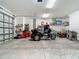 Garage with ample storage and a trike at 27252 & 27260 Porto Nacional Dr, Punta Gorda, FL 33983