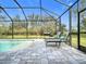 Screened pool area with lounge chairs and paver deck at 27252 Porto Nacional Dr, Punta Gorda, FL 33983