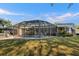 Backyard view of a home with a screened-in pool and patio at 2957 Rock Creek Dr, Port Charlotte, FL 33948