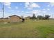 Large backyard with shed and spacious grassy area at 30087 Alder Rd, Punta Gorda, FL 33982