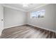 Spacious bedroom featuring wood-look floors and a large window at 30087 Alder Rd, Punta Gorda, FL 33982