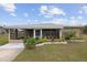 One-story home with screened porch, landscaped yard, and driveway at 30087 Alder Rd, Punta Gorda, FL 33982