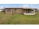Tan house exterior with covered patio at 30087 Alder Rd, Punta Gorda, FL 33982