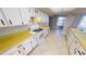 White kitchen cabinets and yellow countertops at 310 Capri Isles Ct, Punta Gorda, FL 33950