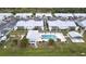 Aerial view of community pool, villas, and surrounding landscape at 3300 Loveland Blvd # 3303, Punta Gorda, FL 33980