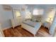 Bright bedroom with light wood floors, a white dresser, and a comfortable bed at 3300 Loveland Blvd # 3303, Punta Gorda, FL 33980
