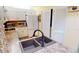Kitchen with white cabinets, double sink, and laundry closet at 3300 Loveland Blvd # 3303, Punta Gorda, FL 33980