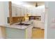 Kitchen features white cabinets, granite counters, and a double sink at 3300 Loveland Blvd # 3303, Punta Gorda, FL 33980