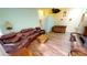 Living room with leather recliners, wood-look floors, and a wet bar at 3300 Loveland Blvd # 3303, Punta Gorda, FL 33980