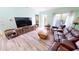 Spacious living room with comfy seating and wood-look floors at 3300 Loveland Blvd # 3303, Punta Gorda, FL 33980
