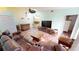 Living room boasts leather furniture and a large TV at 3300 Loveland Blvd # 3303, Punta Gorda, FL 33980