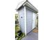 Exterior storage shed with gray siding and white door at 3300 Loveland Blvd # 3303, Punta Gorda, FL 33980