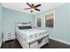 Bright bedroom with a queen-size bed, nightstand, and ceiling fan at 3308 Purple Martin Dr # 135, Punta Gorda, FL 33950