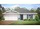 Single story home with two car garage, gray siding, and landscaped lawn at 3332 Jennings Blvd, Port Charlotte, FL 33981
