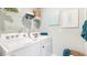 Functional laundry room with Whirlpool appliances and overhead shelving at 3340 Jennings Blvd, Port Charlotte, FL 33981