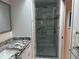Updated bathroom with a walk-in shower and granite vanity at 3761 Peace River Dr, Punta Gorda, FL 33983