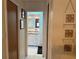 View down hallway to a bright bathroom with double vanity at 3761 Peace River Dr, Punta Gorda, FL 33983