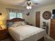 Bedroom with a wooden queen bed and ceiling fan at 3761 Peace River Dr, Punta Gorda, FL 33983